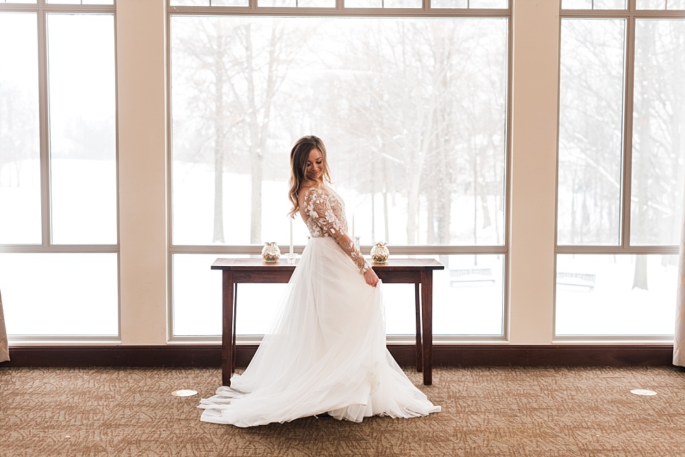 Bride twirls in front of floor to ceiling windows at Scioto Reserve Country Club