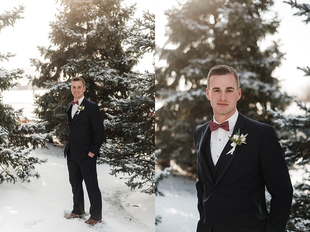 Groom stands in front of snow capped trees for his winter wedding at Scioto Reserve Country Club