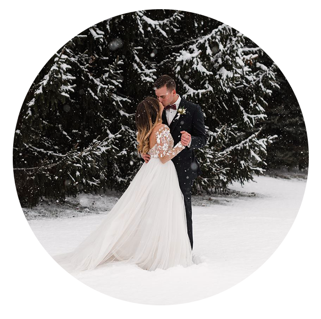 Bride and groom share a kiss while it's snowing at their Scioto Reserve Country Club wedding