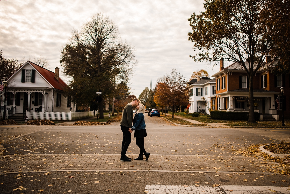 A couple kisses in the middle of the road in Canal Winchester Ohio during fall