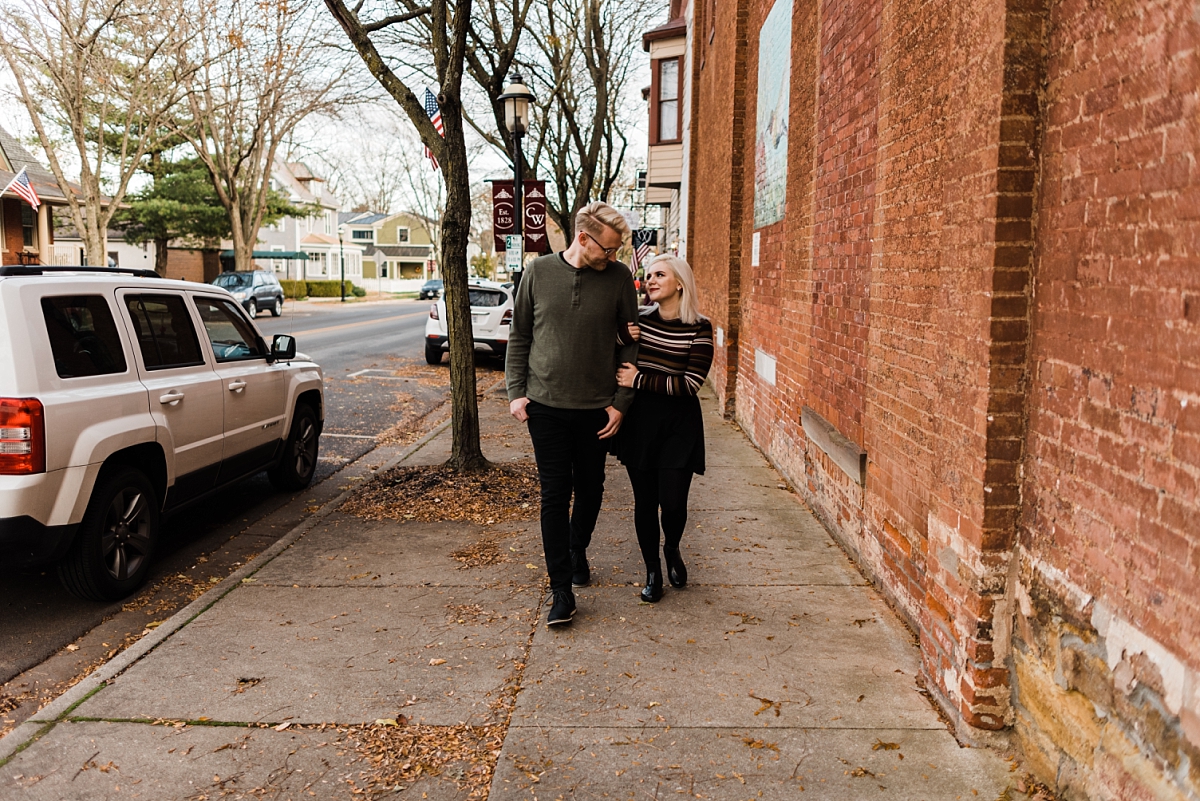 A couple walks through the town of Canal Winchester Ohio for their engagement photos