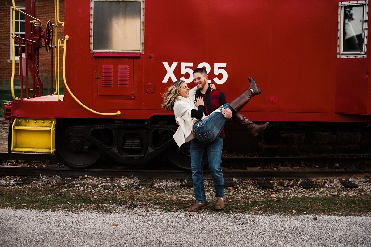 Man spins future wife around in front of old train in Canal Winchester Ohio