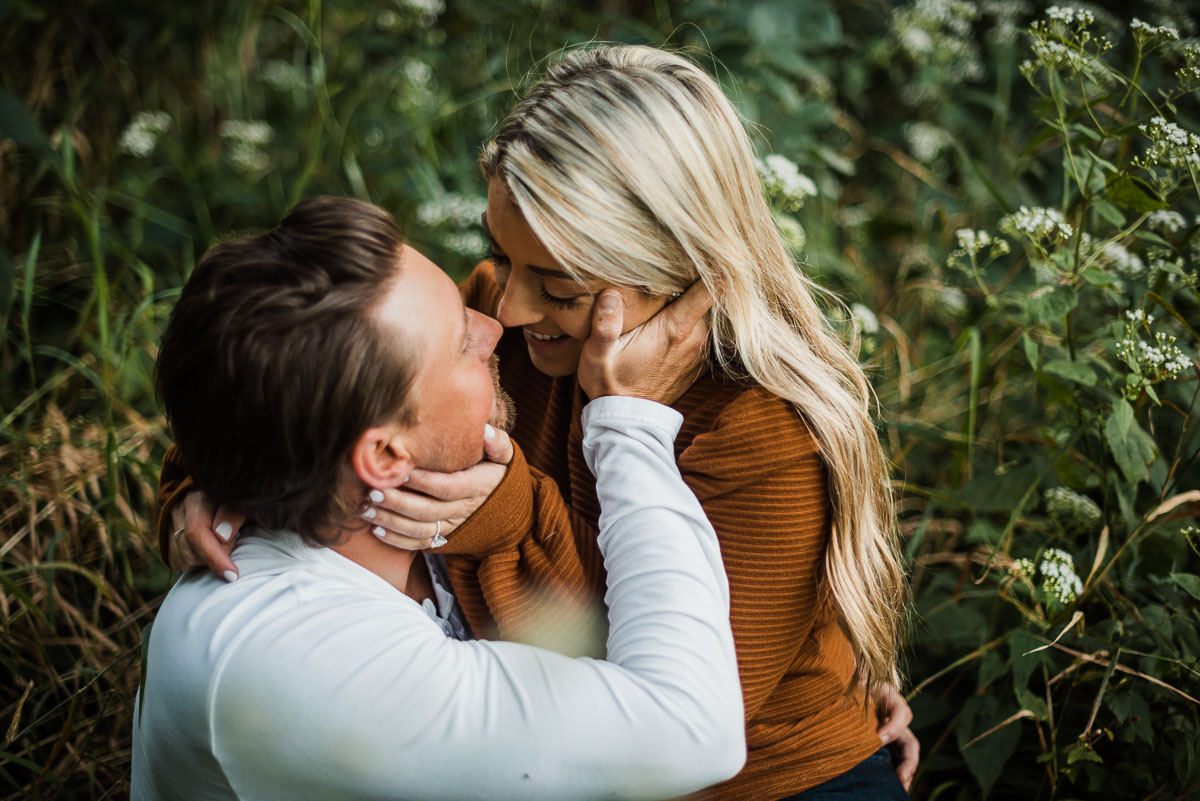 couple goes nose to nose in a field in pickerington ohio for their engagement session
