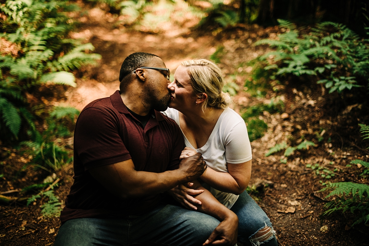 A man and woman kissing during their engagement session at Old Man's Cave