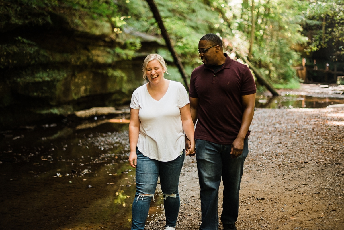 A couple walks through Old Man's Cave for their engagement session