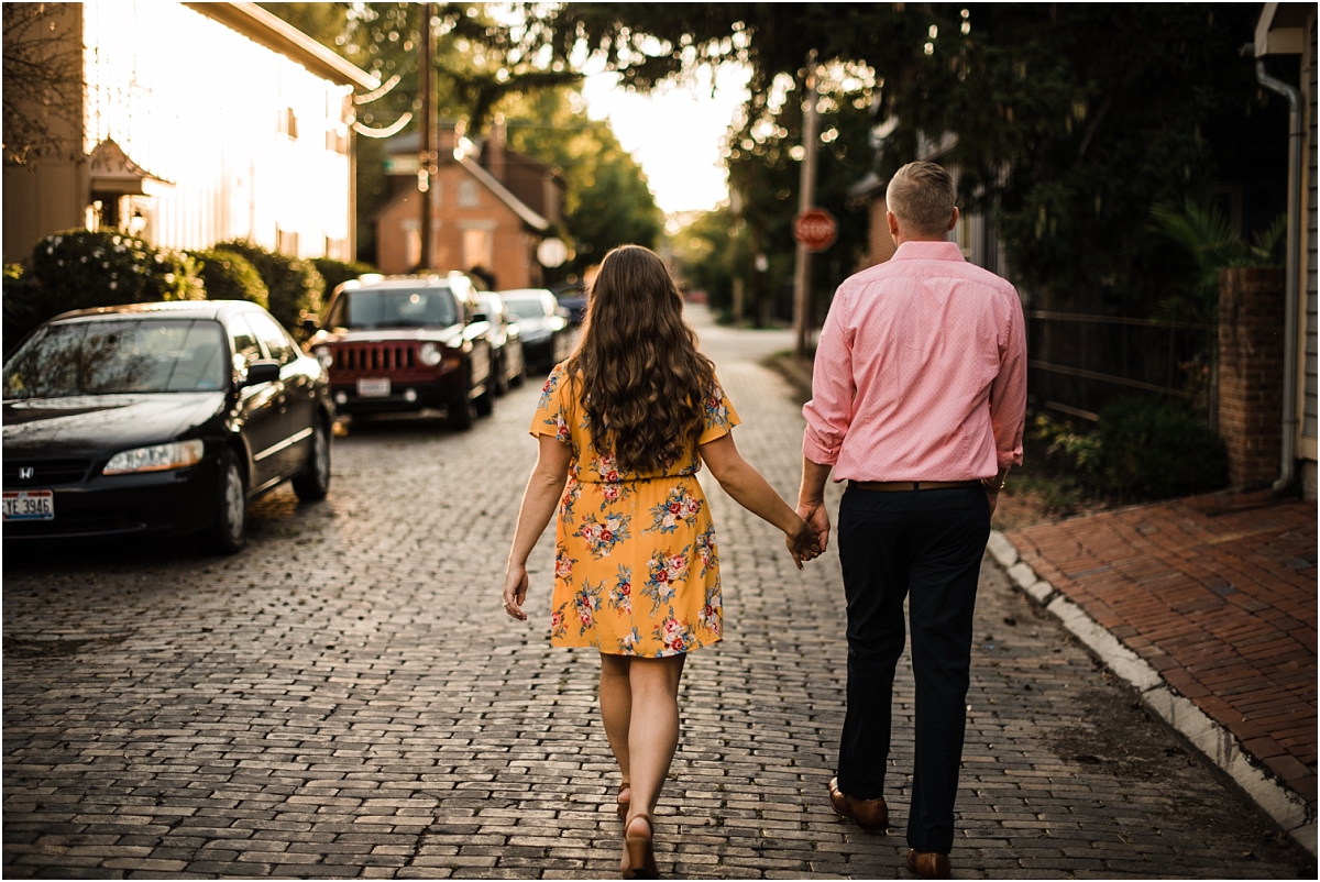 future bride and groom walk along brick roads for engagement session in columbus ohio