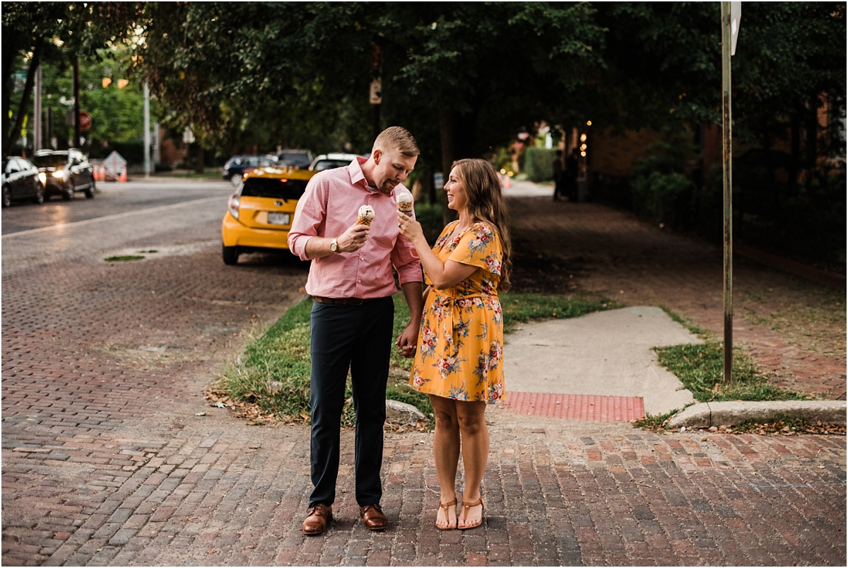 couple shares ice cream during engagement photo session in columbus ohio