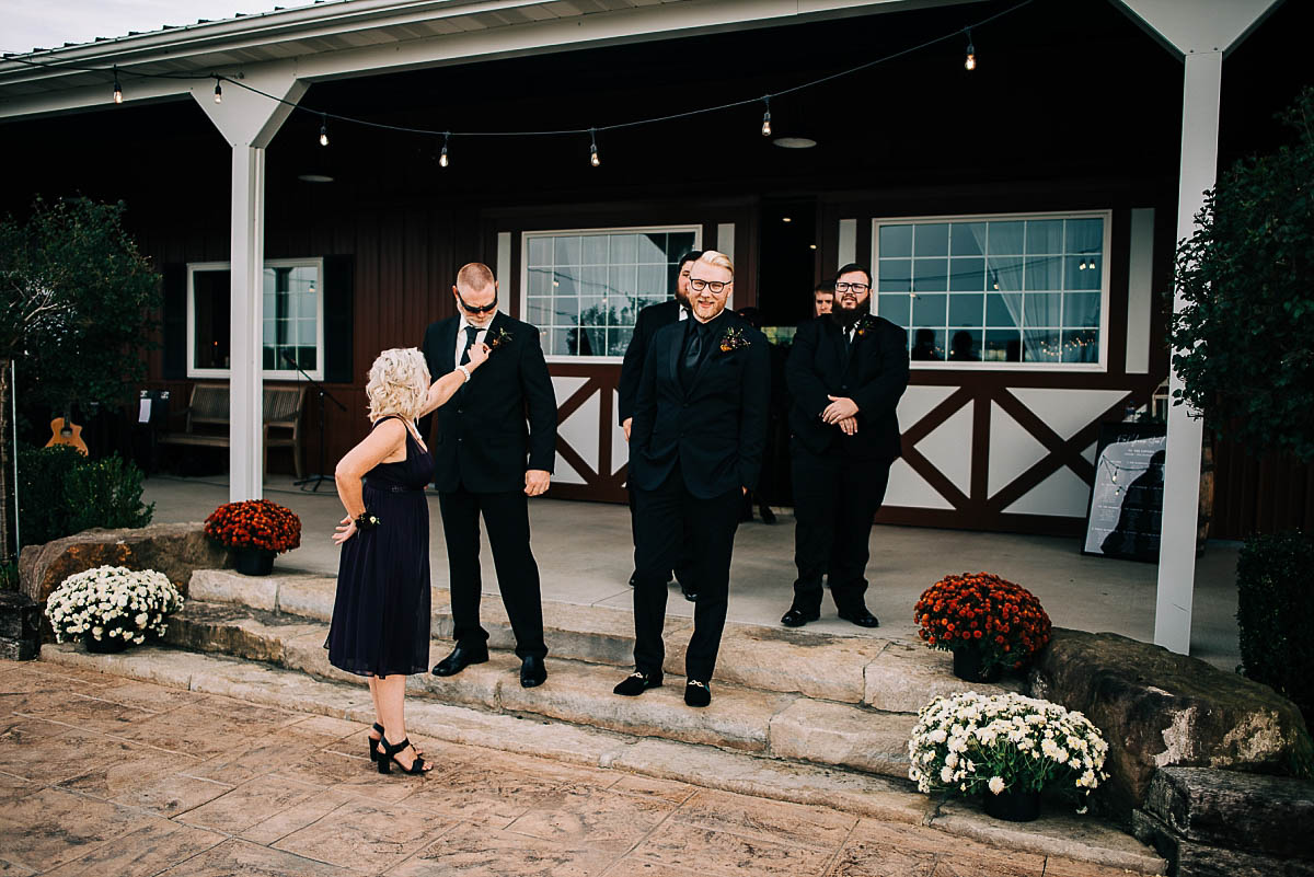 the groom and his groomsmen prepare for the wedding ceremony at the barn at blystone farm