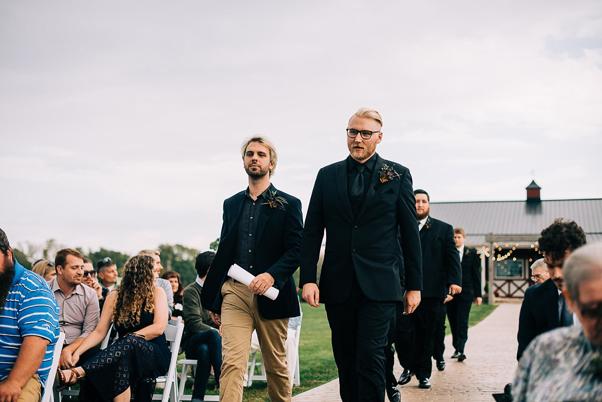 groom walks down aisle on his wedding day