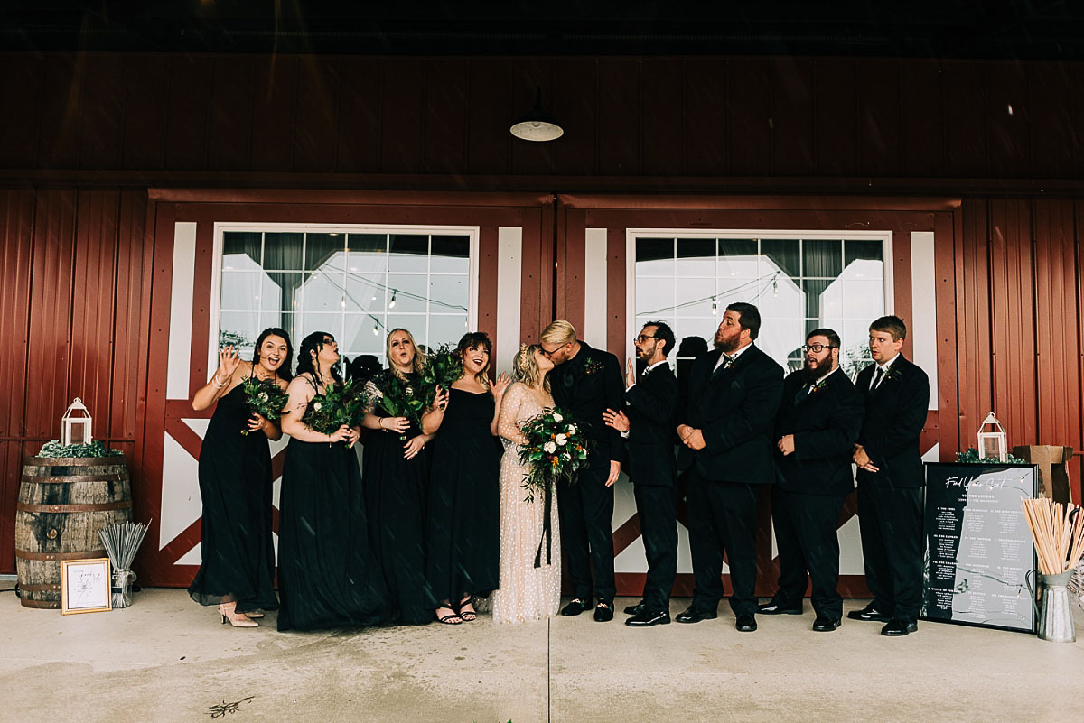 Entire wedding party posing in front of the Barn at Blystone Farm
