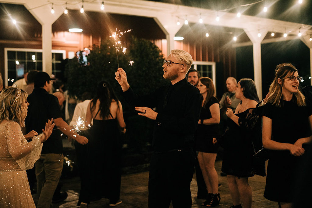 groom is dazzled by a sparkler