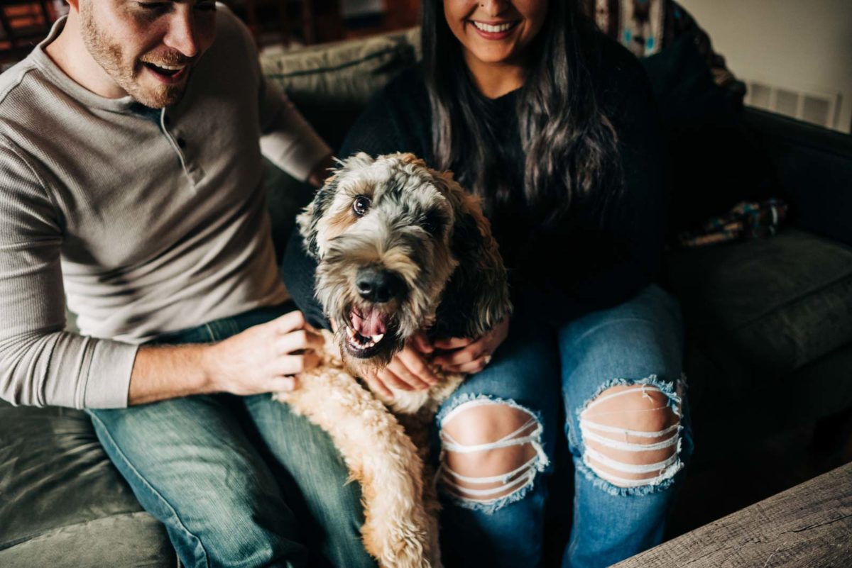 The couples dog is the center of attention during their engagement session