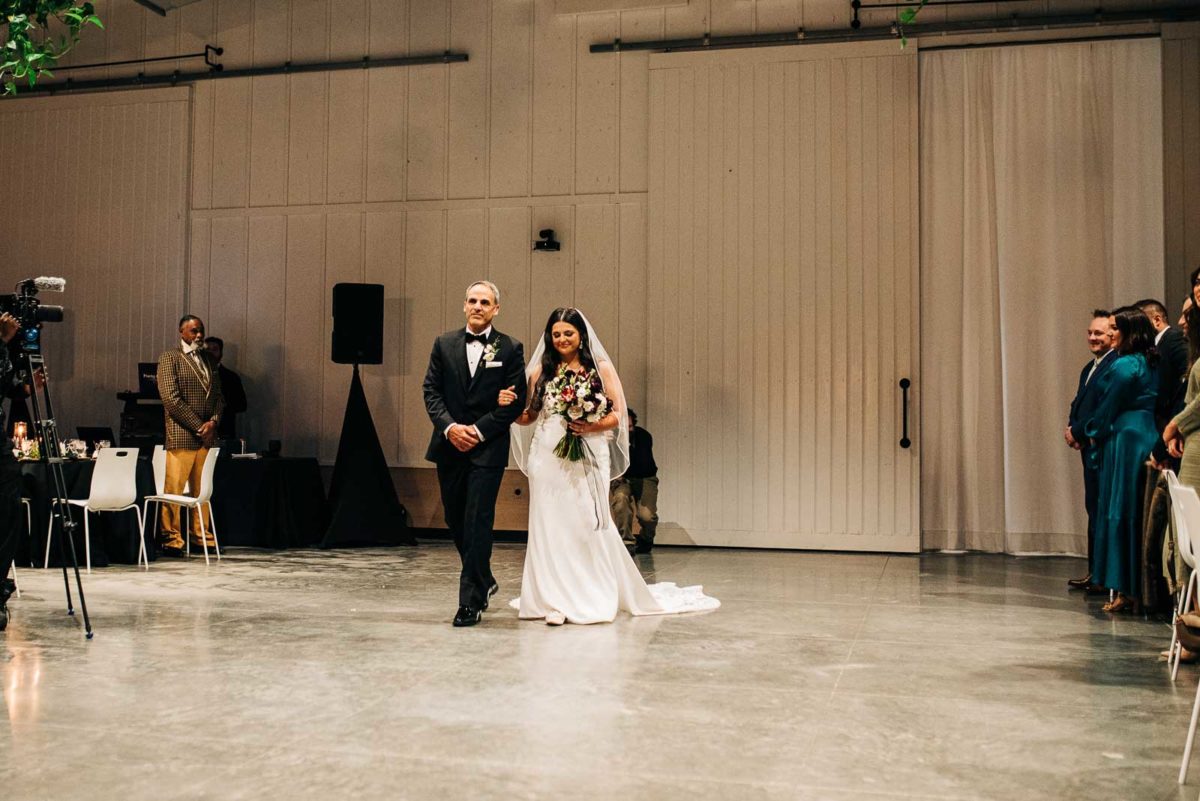 Father of bride walks his daughter down the aisle at Retreat 21 on her wedding day