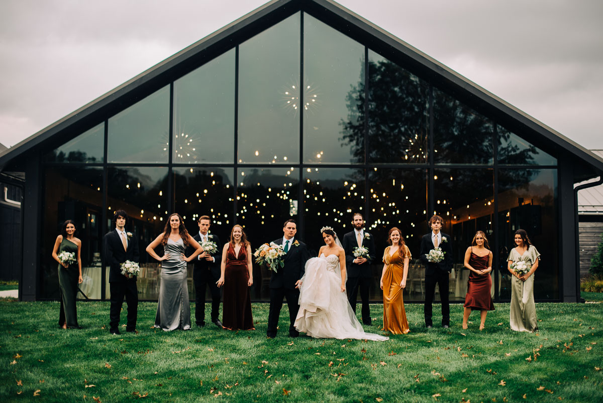 Wedding party poses outside of the Oak Grove building