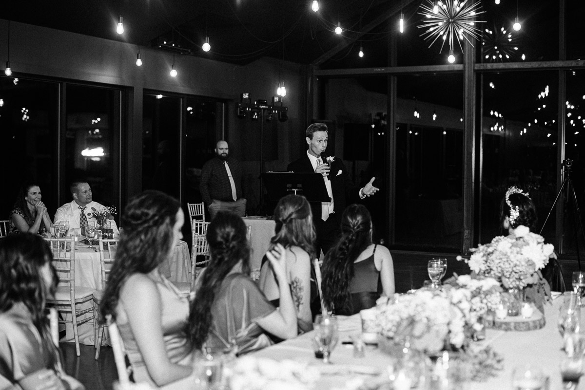 Groomsman gives a toast during the wedding reception at Oak Grove