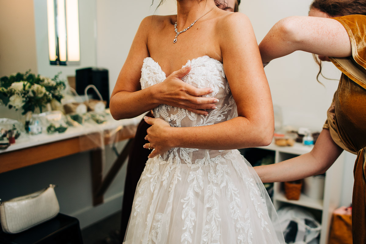 Bride putting her wedding dress on 