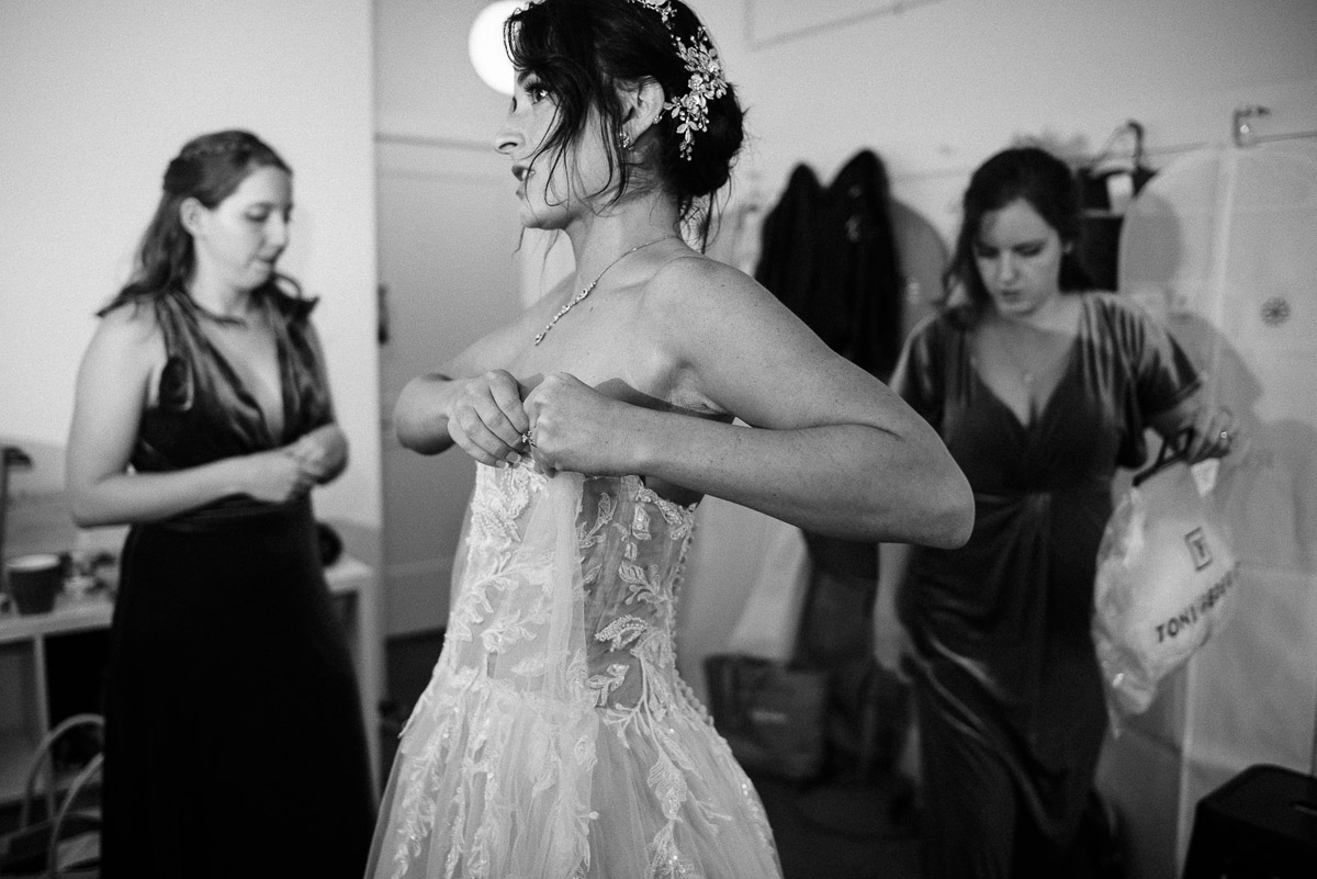 Bride putting her dress on