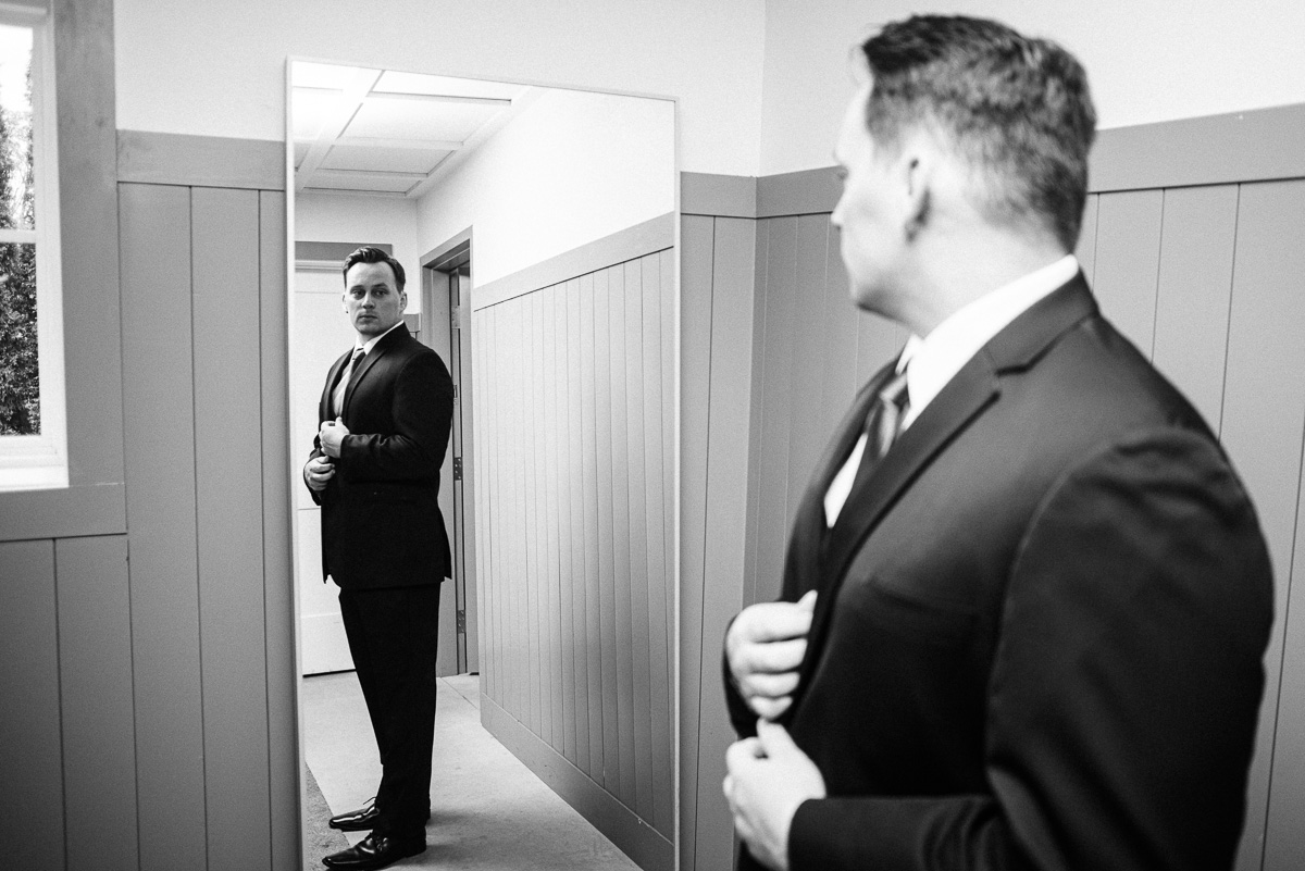 Groom checks himself out in the mirror