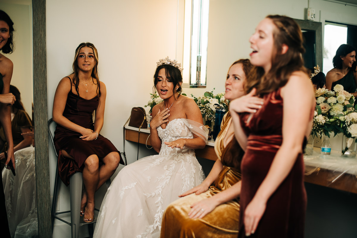 Bride singing a musical number while hanging out in the getting ready suite at Oak Grove