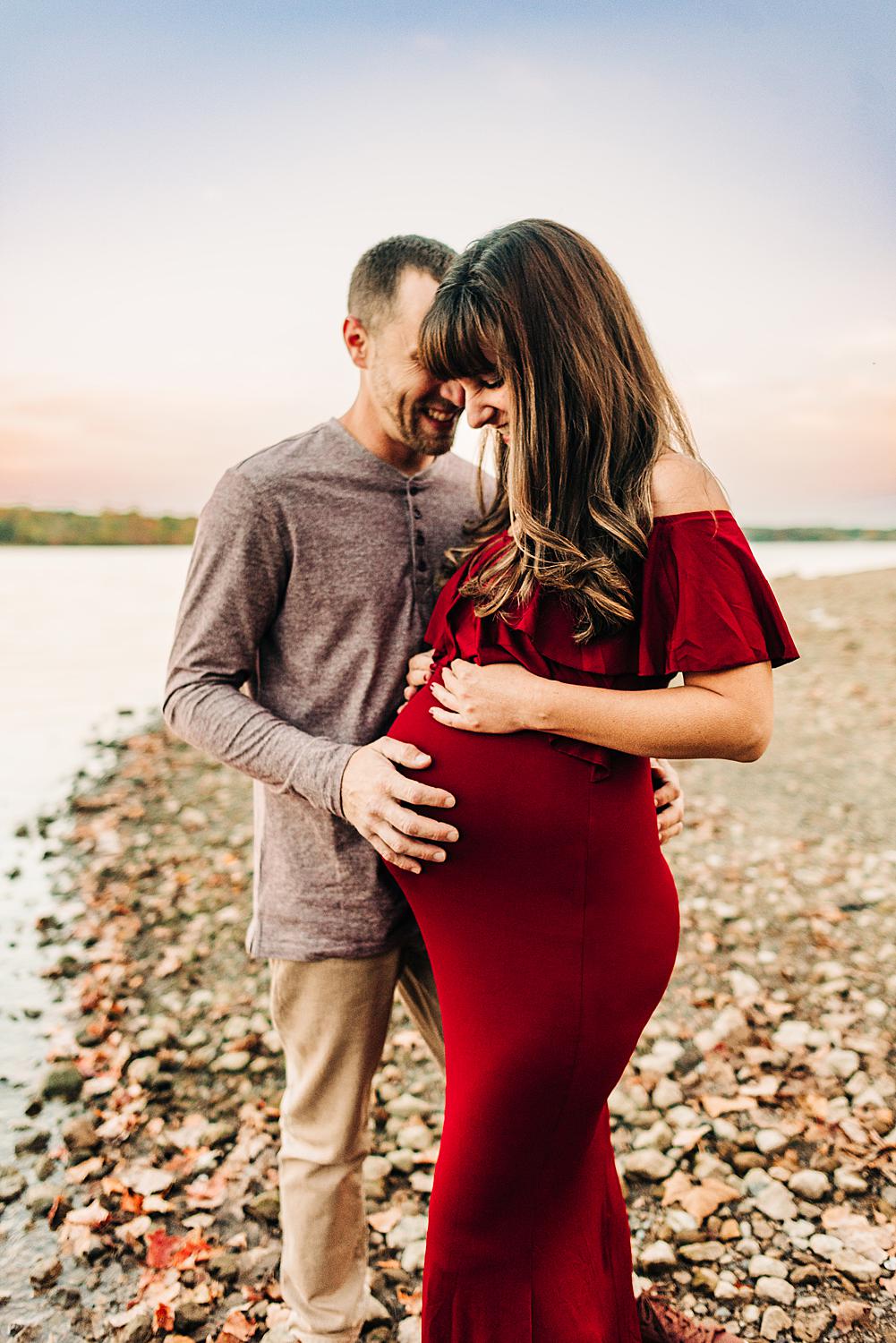 Columbus Ohio maternity photographer poses couple in front of tranquil waters of Hoover Reservoir