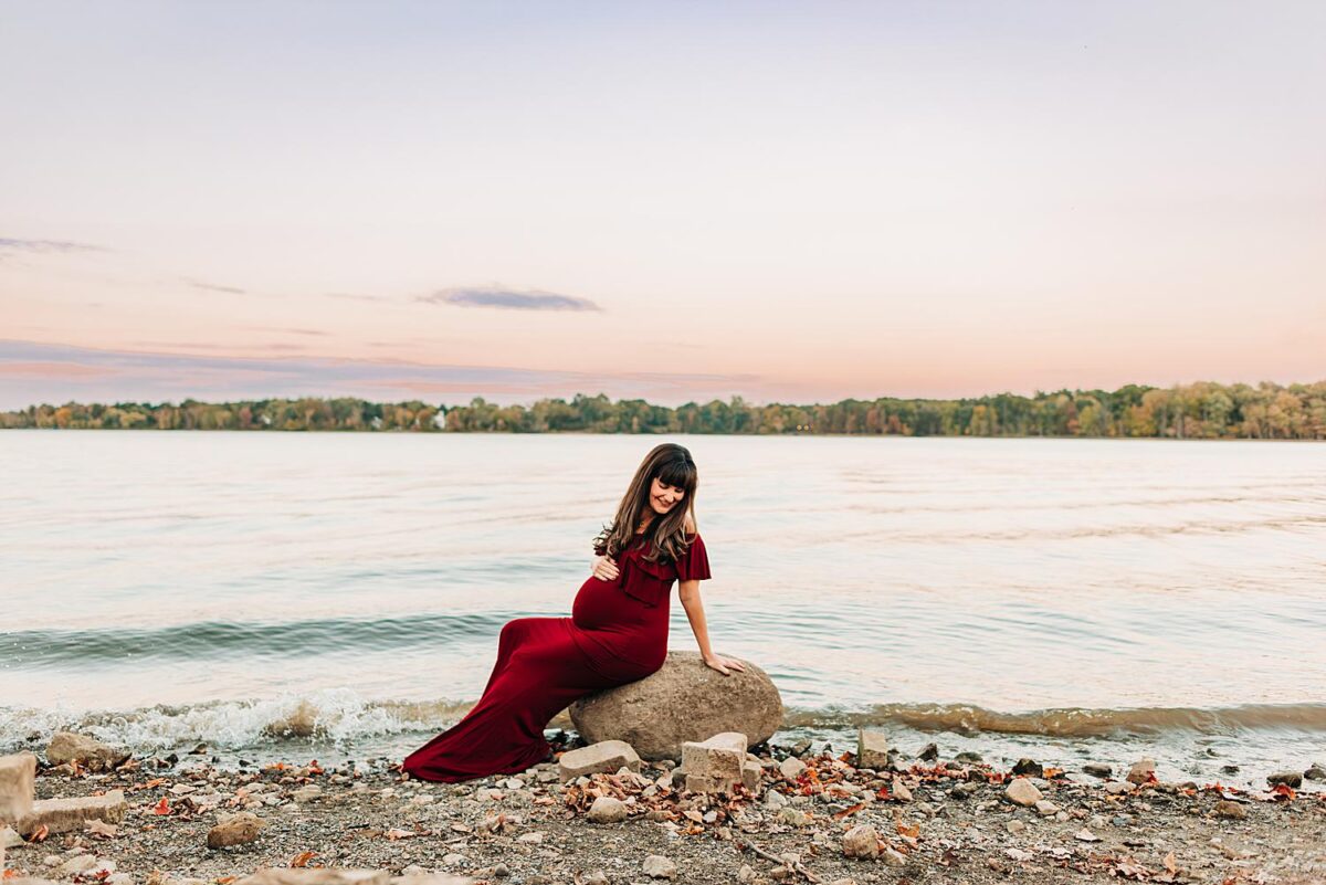 Photographer directs mom to be during her maternity session