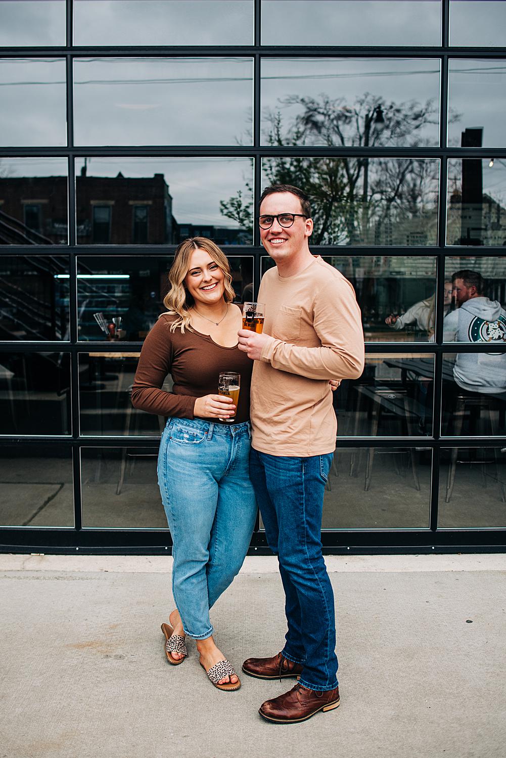 Couple poses outside of Brewdog Franklinton during their engagement session