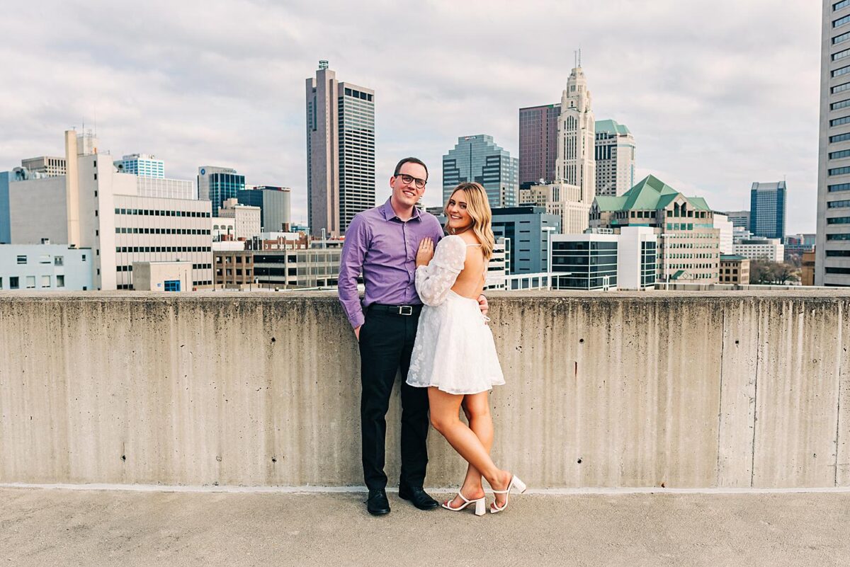 Rooftop engagement photos with a view of Downtown Columbus