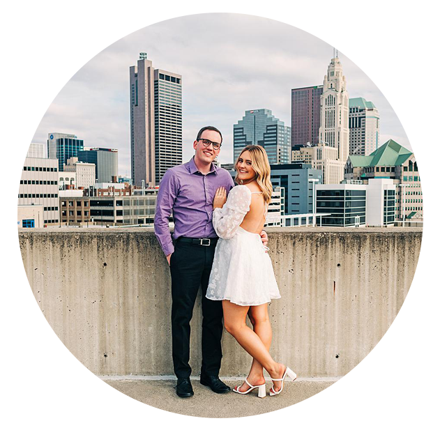 Engaged couple on a parking garage rooftop for their engagement photos