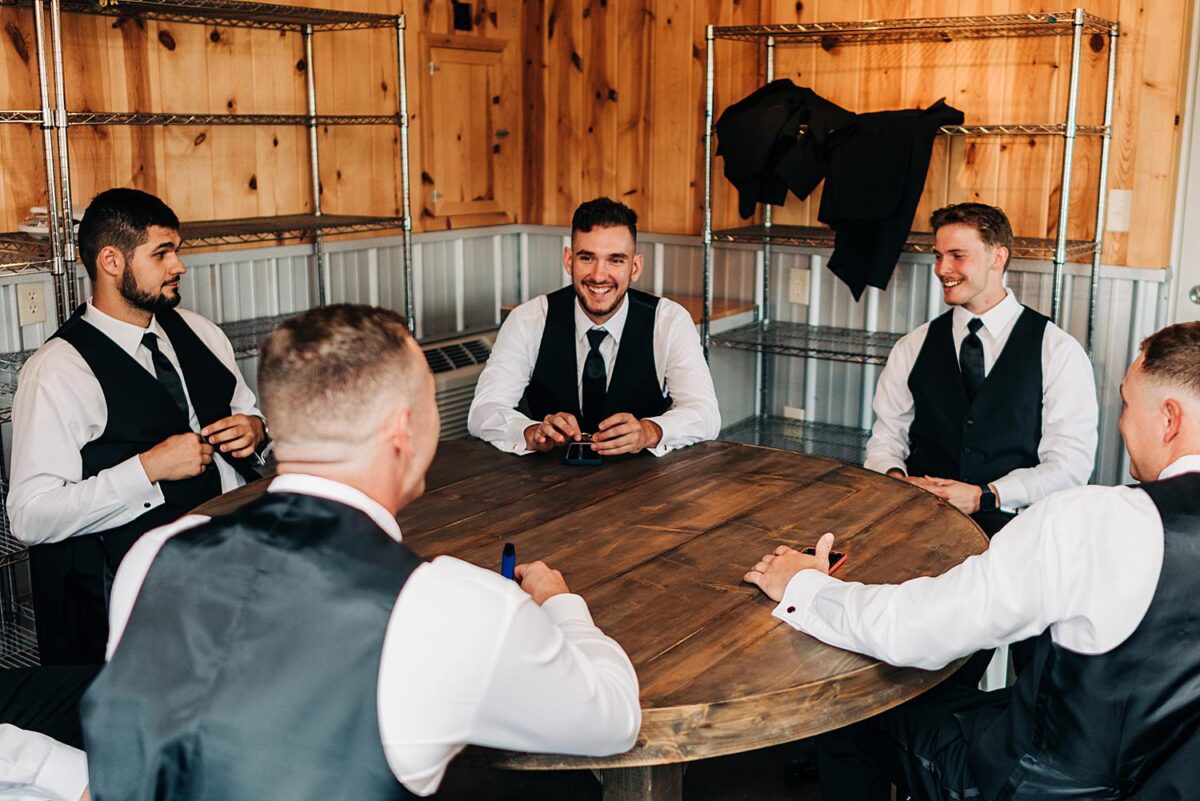Groomsmen hang out in the grooms suite at the Flora and Field wedding venue