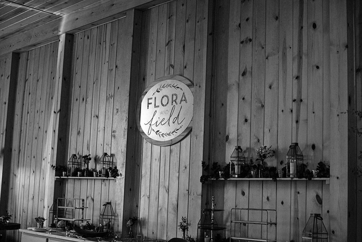 Flora and Field wedding venue sign hanging in the cocktail room