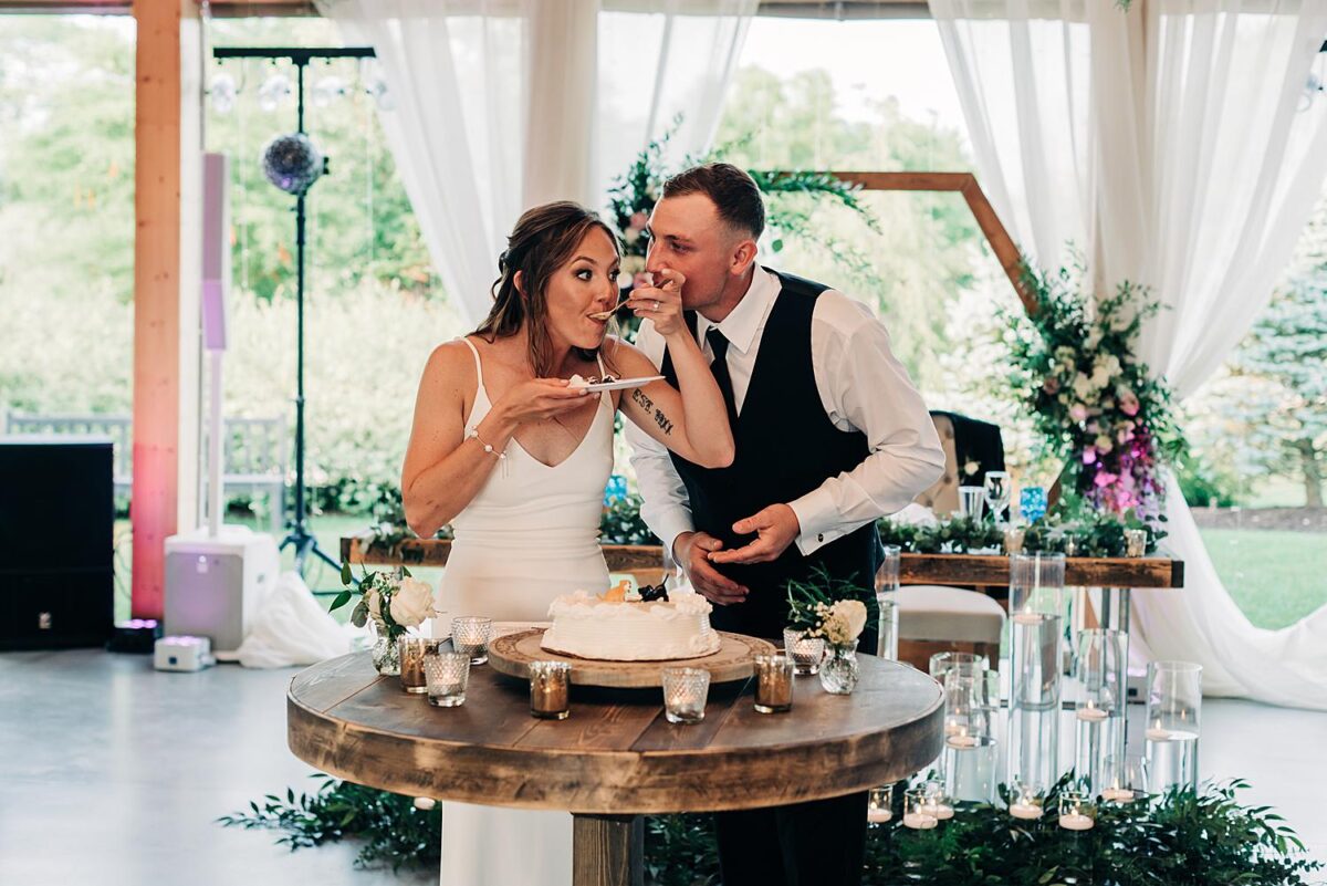 Bride takes a bite of her wedding cake