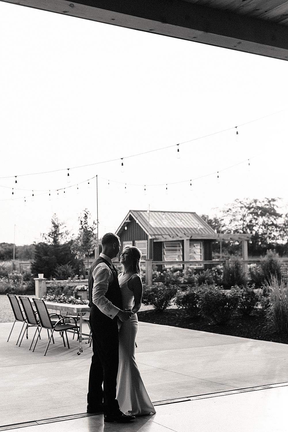 Wedding couple sneaks away for a private moment during wedding reception at Flora and Field