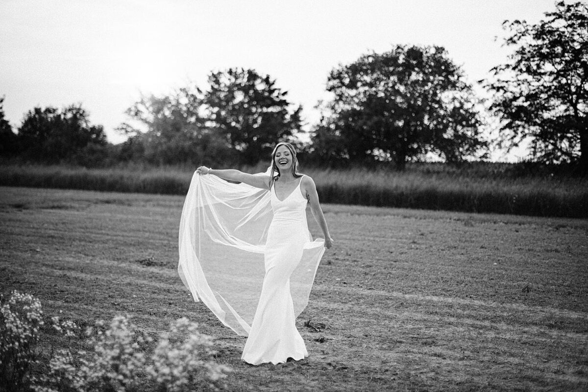 Bride laughs as she twirls in her wedding dress