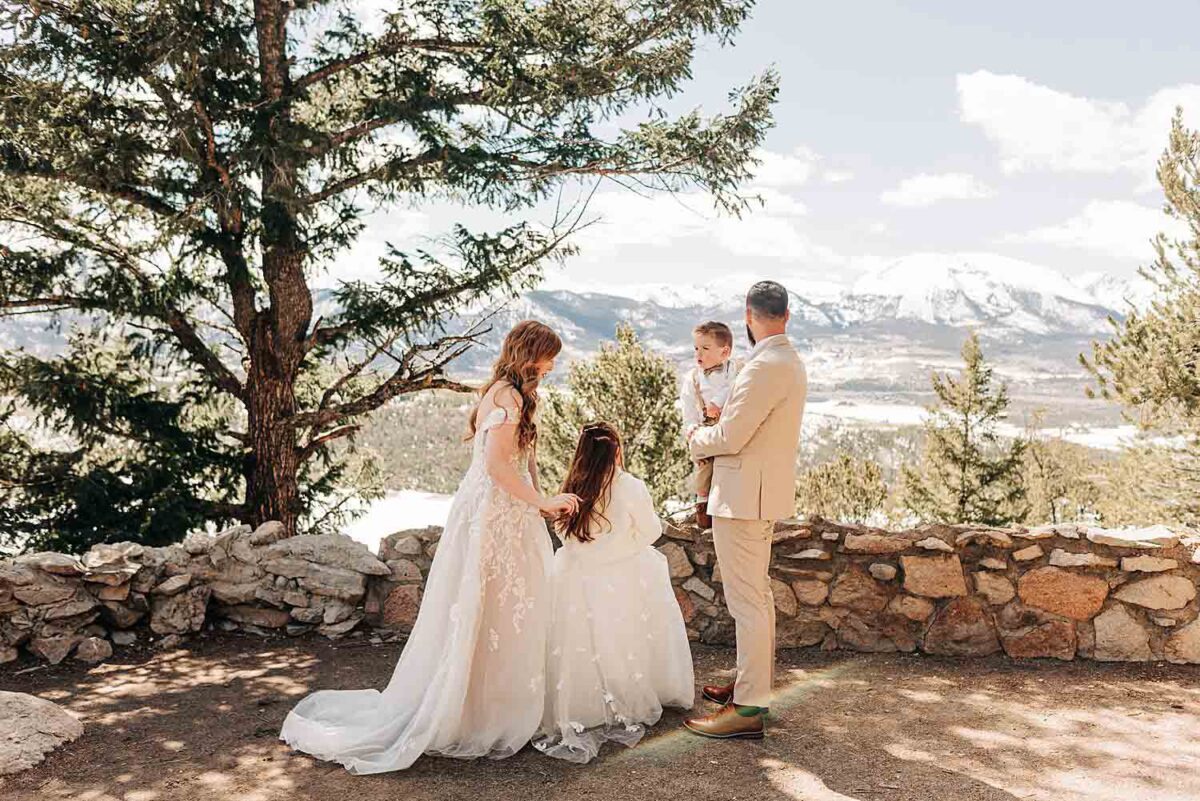 Wedding couple and children prepare for their Sapphire Point Overlook Elopement in Dillon, Colorado.