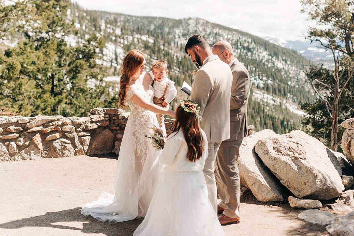 Bride and groom exchange their vows at Sapphire Point Overlook in Dillon, Colorado.