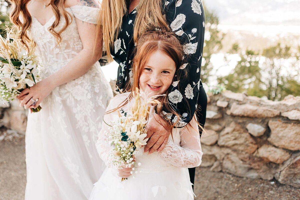 Flower girl smiles at the camera