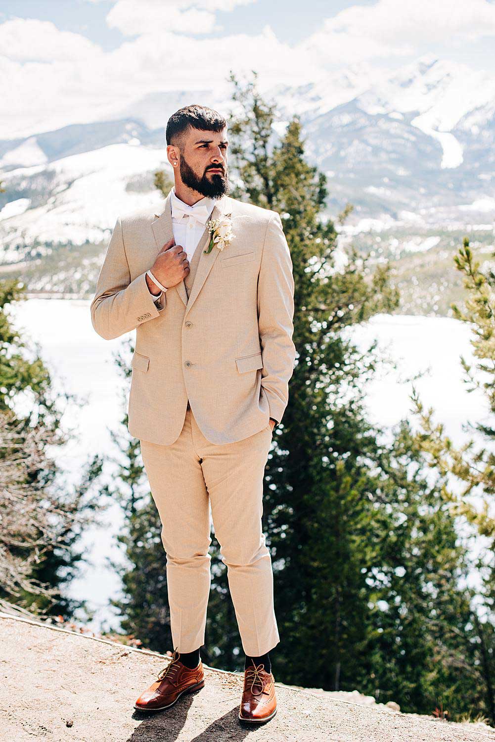 Groom poses for a portrait at Sapphire Point Overlook in Dillon, Colorado